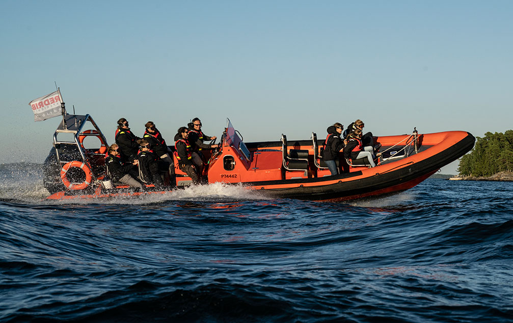 Red RIB boat with customers